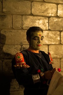 Kathakali dancer in full makeup waiting for his performance