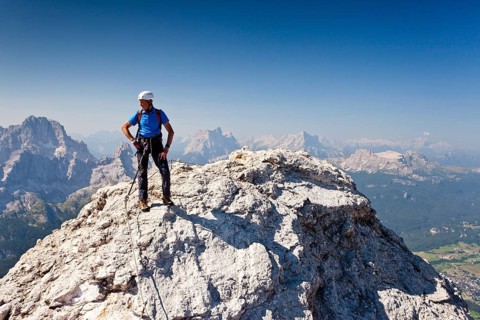 Mountain climber ascending Cristallo di Mezzo along the Via Ferrata Marino Bianchi climbing route on Monte Cristallo above Cortina d'Ampezzo