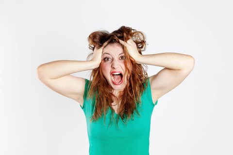 Desperate young woman tearing her hair
