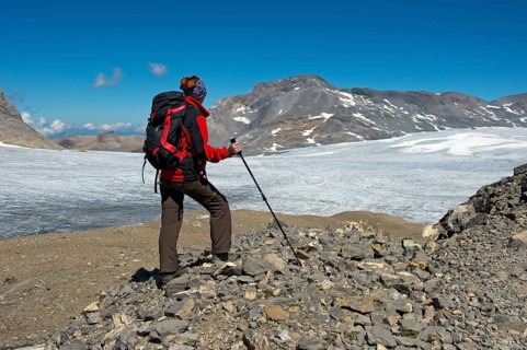 Hiker looking from Pointe de la Plaine Morte over the Plaine Morte Glacier Plateau towards the summit of Wildstrubel Mountain