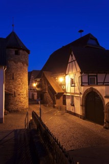Historical Town Hall with a fortified wall and the tower of a fortified church