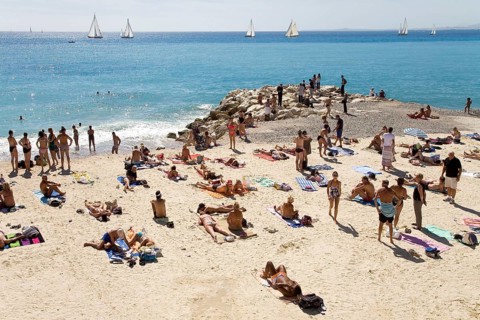 Tourists on the beach on Promenade des Anglais