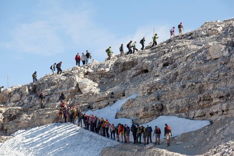 Tailback of climbers on the hiking trail below Mt Piz Boe