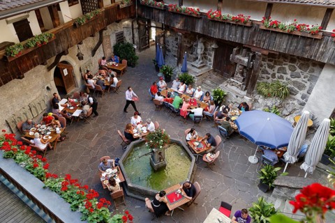 Courtyard of Schattenburg Castle with a restaurant