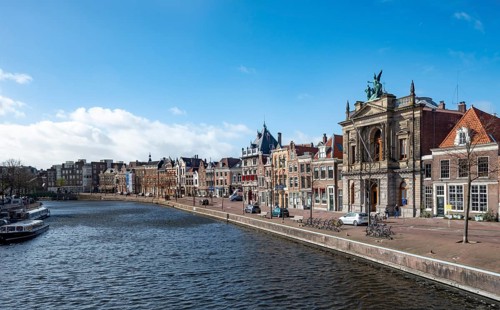 Gracht Spaarne with historic houses and Teylers Museum