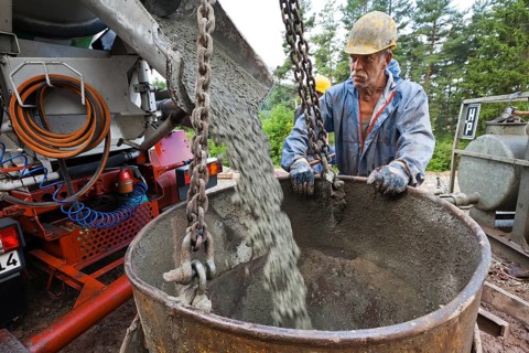 Worker preparing the pile foundation for the concrete piles for the power masts of a 380 kV high-voltage line