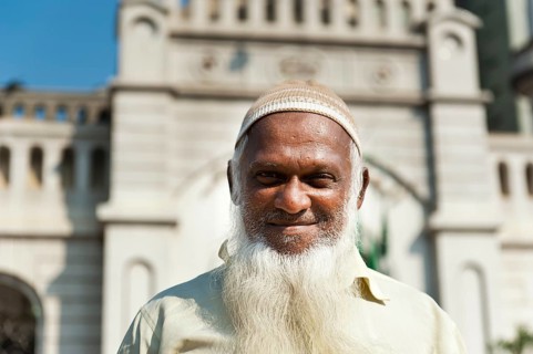 Devout Muslim with cap and long white beard