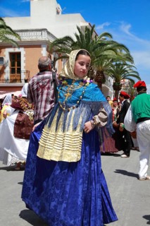 Young woman in traditional costume performing typical dance