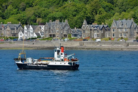 Ship of the Caledonian MacBrayne shipping company in front of the Victorian houses of the town of Oban