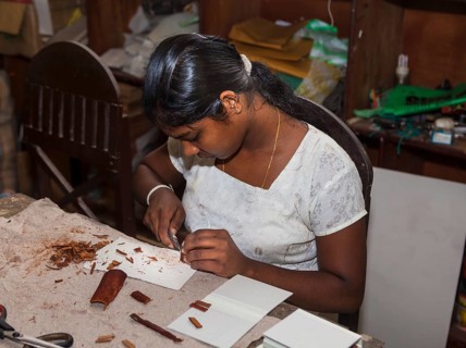 Young woman making wood jewelry