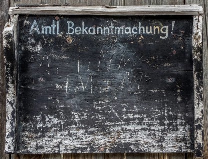 Old information board with the inscription 'Amtliche Bekanntmachung'