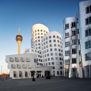 Rheinturm or Rhine Tower with two of the Gehry buildings at Neuer Zollhof