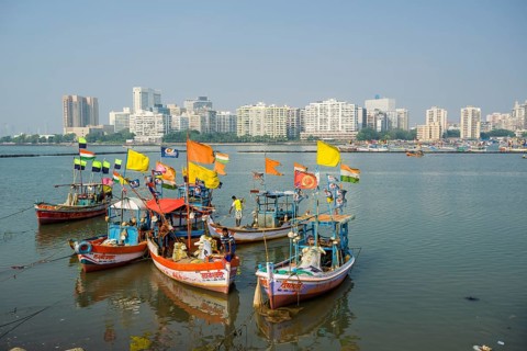 The skyline of the suburb Churchgate seen across the Back Bay with some fishing boats
