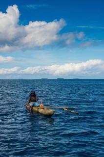 Fishing woman in an outrigger boat