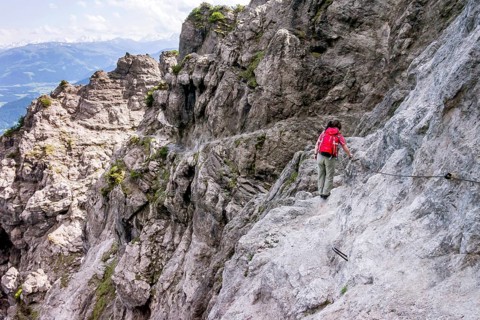 Female hiker walking along the fixed cable route of Jubilaeumssteig