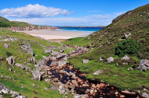 The Allt Chailgeag stream transporting brown bog water into Rispond Bay
