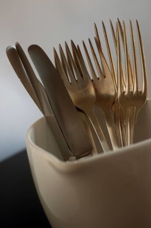 Old silverplated cutlery in milk jug