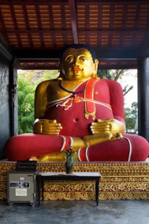 Gilded Buddha beside a safe in the courtyard of Wat Chedi Luang Temple