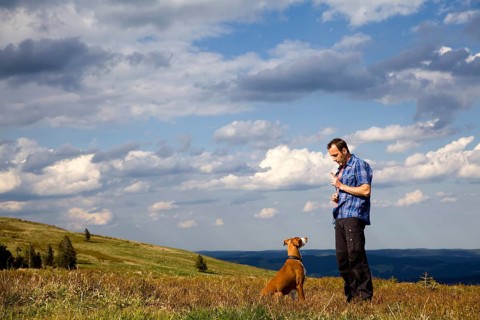 Man making his dog 'sit'