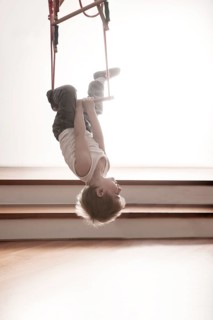 Young boy exercising on a swing