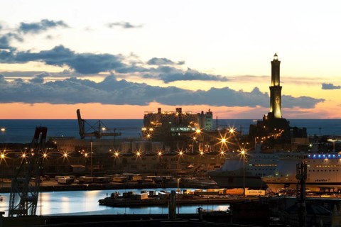 The Lighthouse of Genoa with cruise ship in the Porto Antico harbour