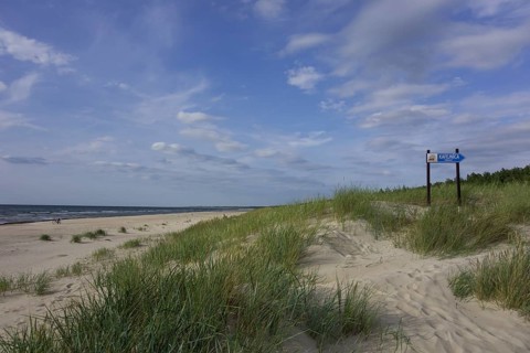 Sandy beach on the Baltic Sea with sign for a cafe