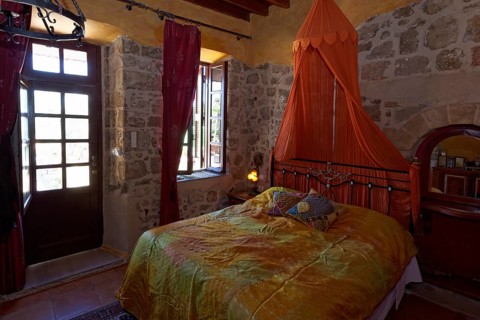 Romantic hotel room with canopy and metal bed