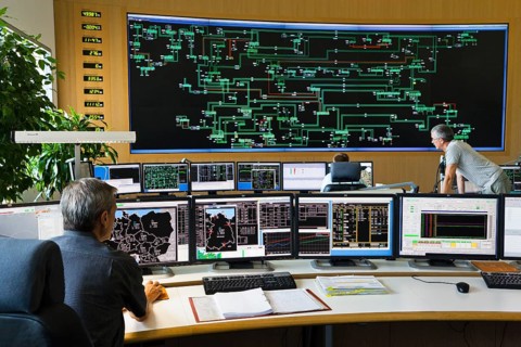 Shift supervisor Hans-Peter Polzer sitting at his work station in the Transmission Control Center