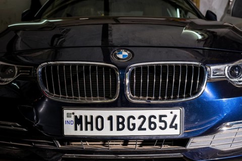 The front of a German BMW car with a Maharasthra number plate