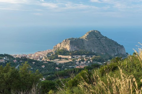 Limestone rock Rocca di Cefalu with the town of Cefalu