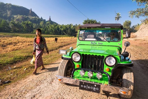 Woman walking next to a four-wheel drive vehicle