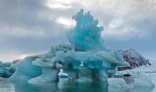 Iceberg tourists in a rubber dinghy