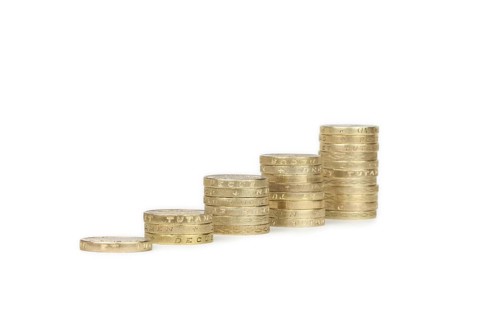 Piles of UK sterling pound coins