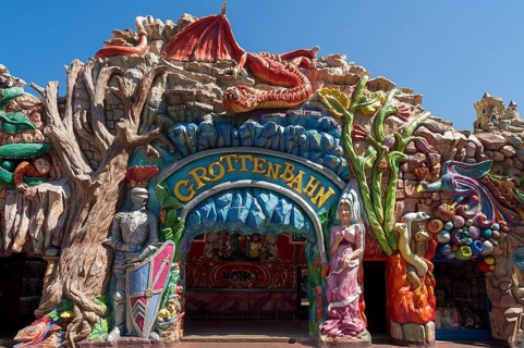 Entrance to the 'Grottenbahn' fairground ride decorated with figures