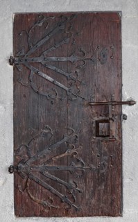Medieval wooden door with ornate ironwork