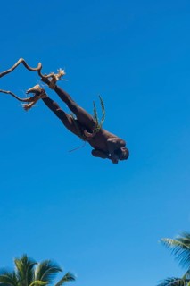 Man jumping from a bamboo tower