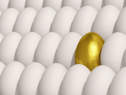 Golden egg amidst white eggs