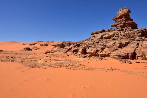 Sandstone rock towers and sand dunes at Tin Merzouga