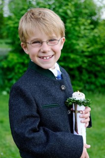 Boy holding a First Communion candle
