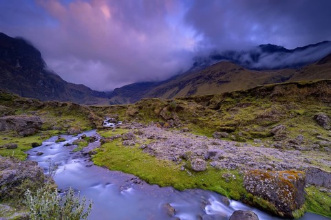 Mountain stream with the peaks of El Altar or Kapak Urku