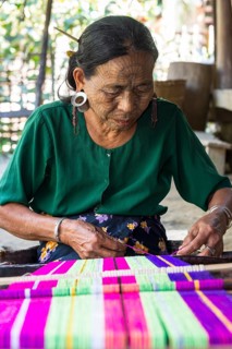 Woman with traditional facial tattoos and ear jewellery from the Chin people