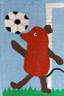 Mouse figure playing football
