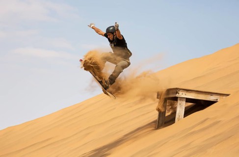 Sand boarding in the dunes of the Namib Desert