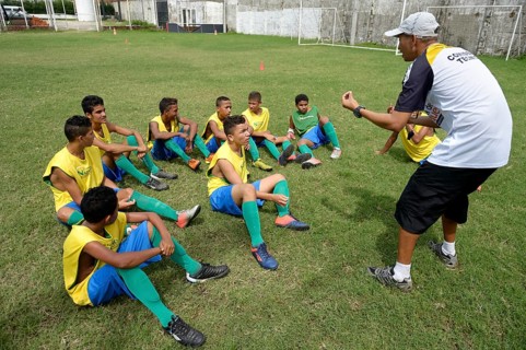 Coach giving young players technical instructions