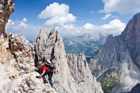 Mountain climber ascending Plattkofel Mountain along the Oskar-Schuster Stieg climbing route