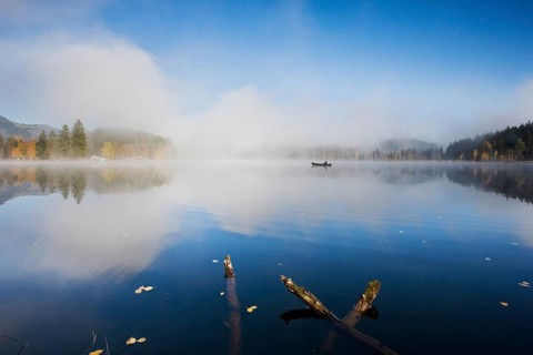 Schwarzsee with fishing boat in the morning mist