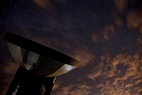 Satellite earth station in front of the night sky