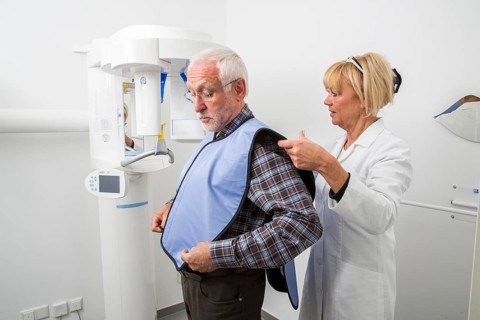 Man being prepared for an X-ray of his teeth