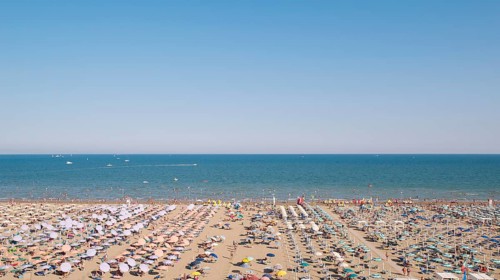 View of a beach with sunshades and sun beds in the afternoon