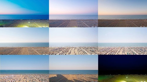 24-hour beach view with parasols and sunloungers